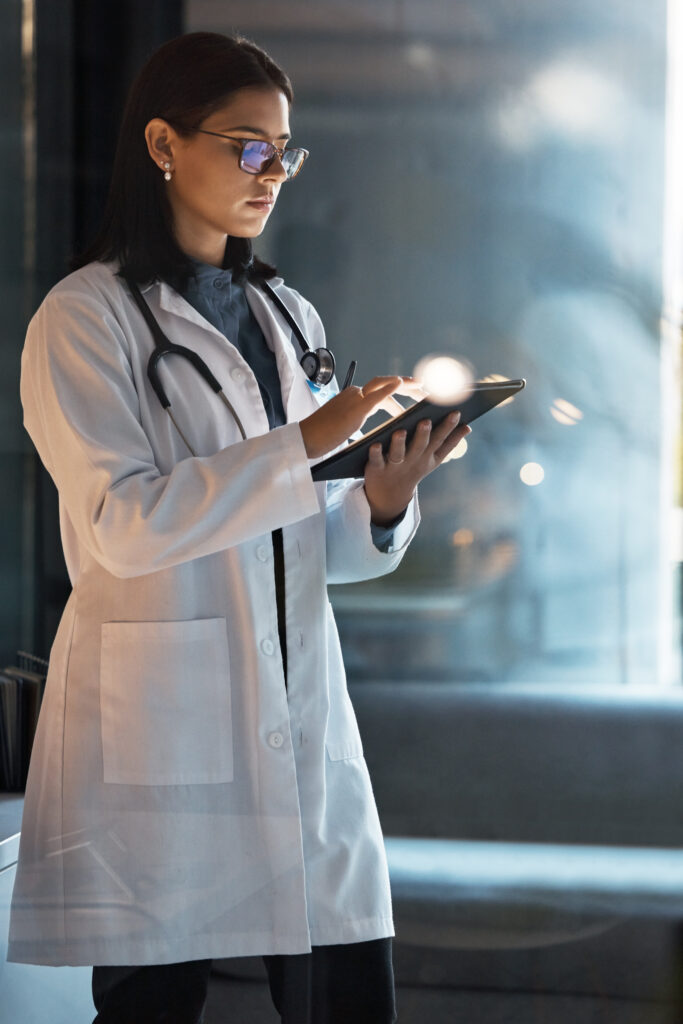 Female doctor at night in medical office.